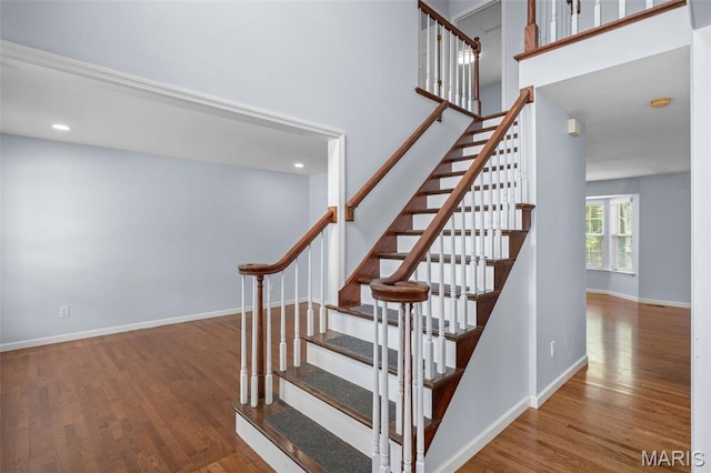 12101 Fahrpark Ln, Saint Louis, MO 63146 - stairway with wood finished floors, recessed lighting, and a towering ceiling