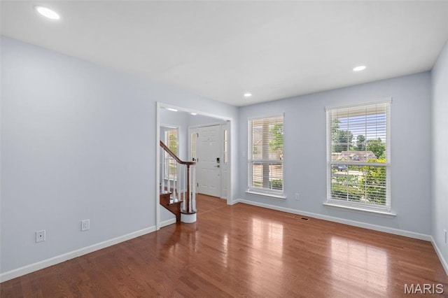 12101 Fahrpark Ln, Saint Louis, MO 63146 - empty room featuring stairway, wood finished floors, and recessed lighting