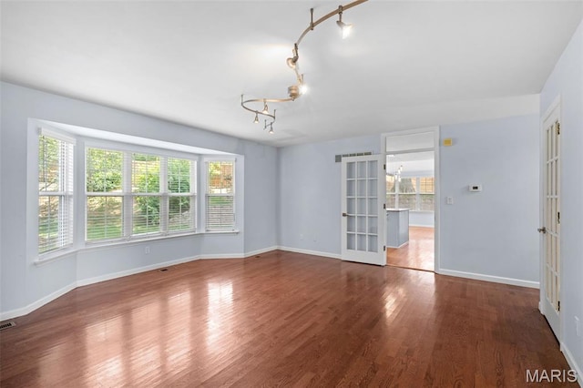 12101 Fahrpark Ln, Saint Louis, MO 63146 - unfurnished room with a chandelier, wood finished floors, french doors, and rail lighting