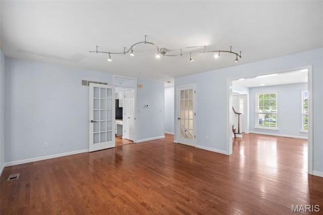 12101 Fahrpark Ln, Saint Louis, MO 63146 - empty room with french doors, wood finished floors, and track lighting