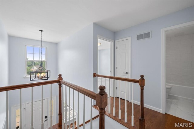 12101 Fahrpark Ln, Saint Louis, MO 63146 - corridor featuring an upstairs landing, a chandelier, and marble finish floors