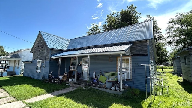 526 N Locust St, Dexter, MO 63841 - view of front of home with a porch, a front yard, and metal roof