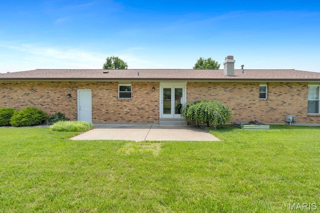 3100 Tally Ho Dr, Saint Charles, MO 63301 - back of property featuring a patio area, brick siding, a lawn, and a chimney