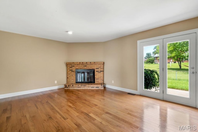 3100 Tally Ho Dr, Saint Charles, MO 63301 - unfurnished living room featuring light wood finished floors and a fireplace