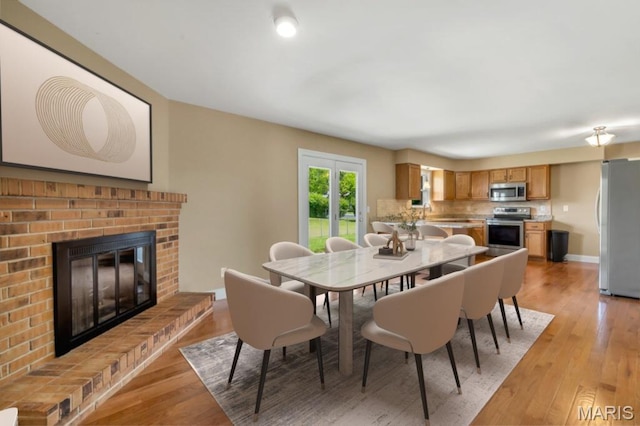 3100 Tally Ho Dr, Saint Charles, MO 63301 - dining space with light wood finished floors and a fireplace