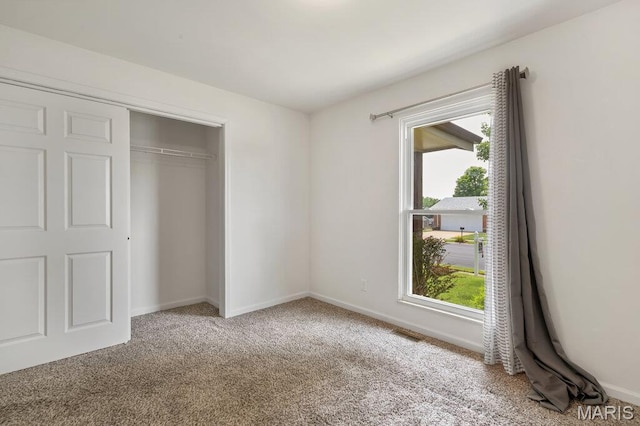 3100 Tally Ho Dr, Saint Charles, MO 63301 - unfurnished bedroom featuring carpet floors, multiple windows, and a closet