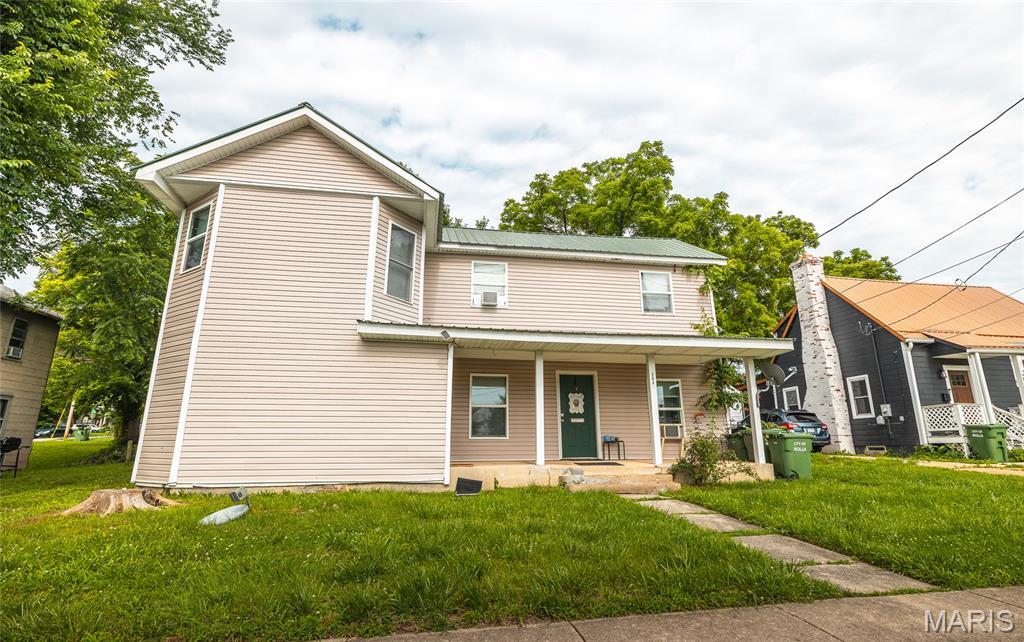 204 N Olive St, Rolla, MO 65401 - view of front facade featuring covered porch, a front lawn, and a metal roof