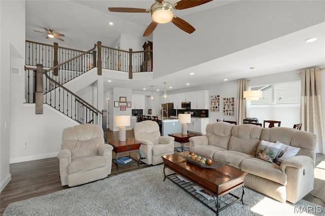 145 Royal Inverness Pkwy, Dardenne Prairie, MO 63368 - living room featuring ceiling fan, wood finished floors, stairway, recessed lighting, and a high ceiling