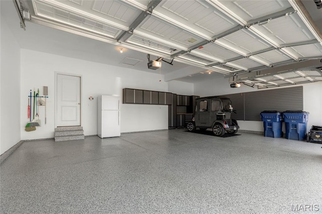 145 Royal Inverness Pkwy, Dardenne Prairie, MO 63368 - garage with freestanding refrigerator and a garage door opener
