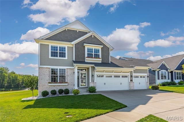 145 Royal Inverness Pkwy, Dardenne Prairie, MO 63368 - view of front of house featuring a front lawn, concrete driveway, brick siding, and a garage