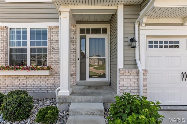 145 Royal Inverness Pkwy, Dardenne Prairie, MO 63368 - entrance to property featuring brick siding, a garage, and covered porch