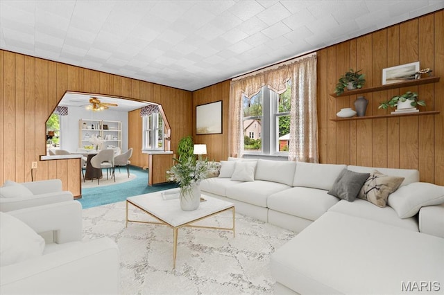 542 S Main St, Waterloo, IL 62298 - living area with wood walls, healthy amount of natural light, a ceiling fan, and carpet