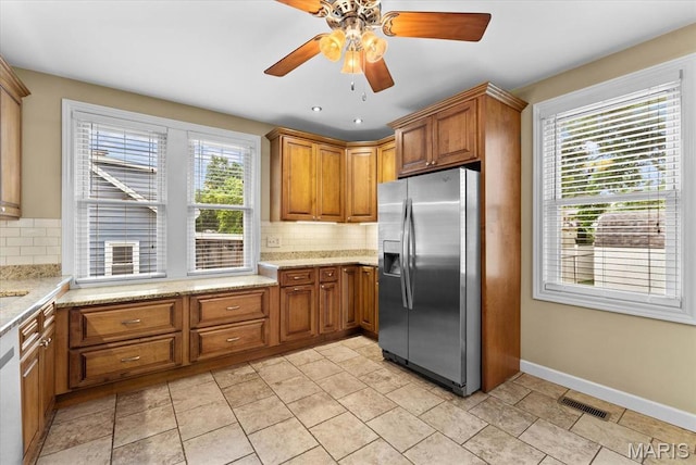 542 S Main St, Waterloo, IL 62298 - kitchen with stainless steel appliances, brown cabinets, backsplash, a ceiling fan, and recessed lighting