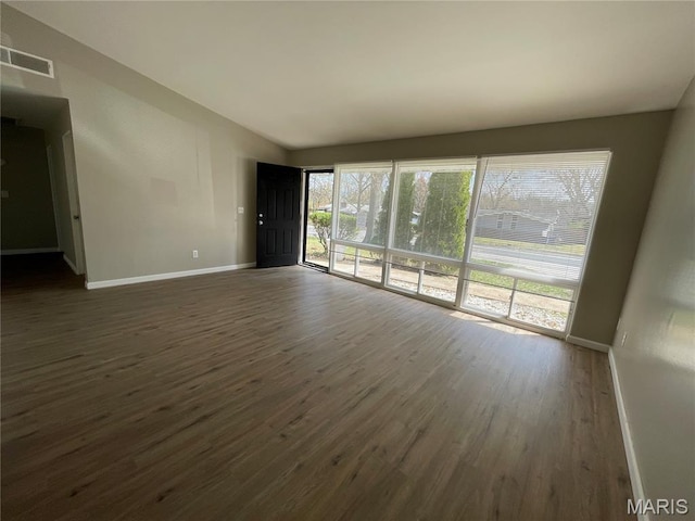 415 Waterford Dr, Florissant, MO 63033 - unfurnished living room with dark wood-style floors and lofted ceiling