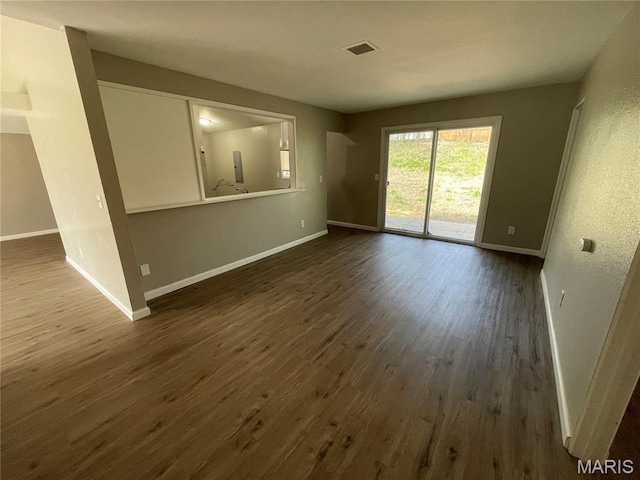 415 Waterford Dr, Florissant, MO 63033 - unfurnished living room with baseboards and dark wood-type flooring