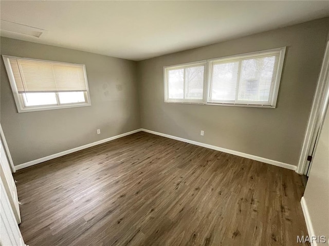 415 Waterford Dr, Florissant, MO 63033 - empty room featuring healthy amount of natural light and dark wood-style floors
