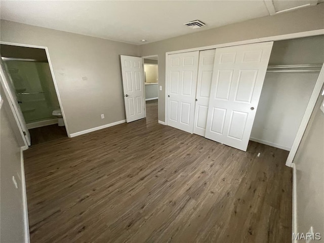 415 Waterford Dr, Florissant, MO 63033 - unfurnished bedroom featuring dark wood finished floors, a closet, and ensuite bath