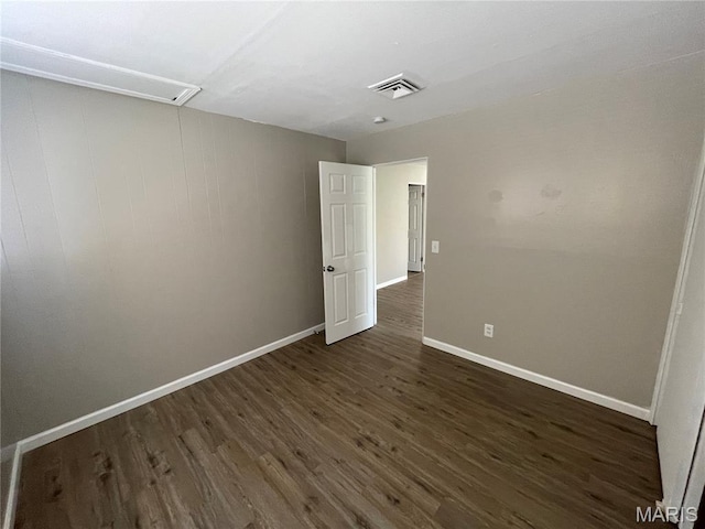 415 Waterford Dr, Florissant, MO 63033 - spare room with dark wood-style flooring and attic access