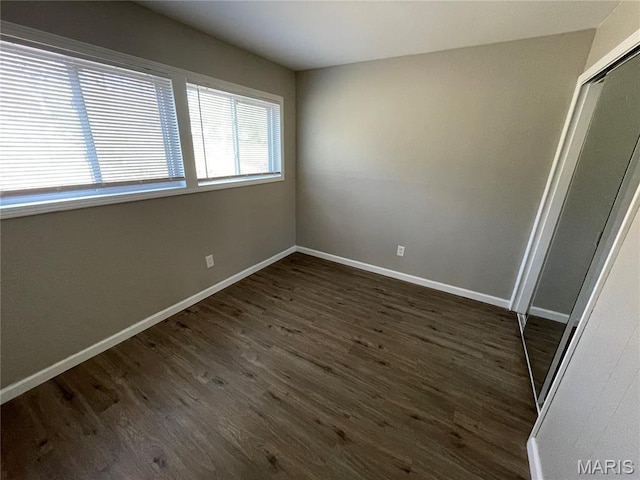 415 Waterford Dr, Florissant, MO 63033 - unfurnished room featuring dark wood-style flooring and baseboards