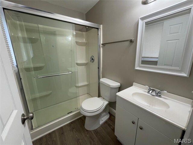 415 Waterford Dr, Florissant, MO 63033 - bathroom featuring wood finished floors, a stall shower, and vanity