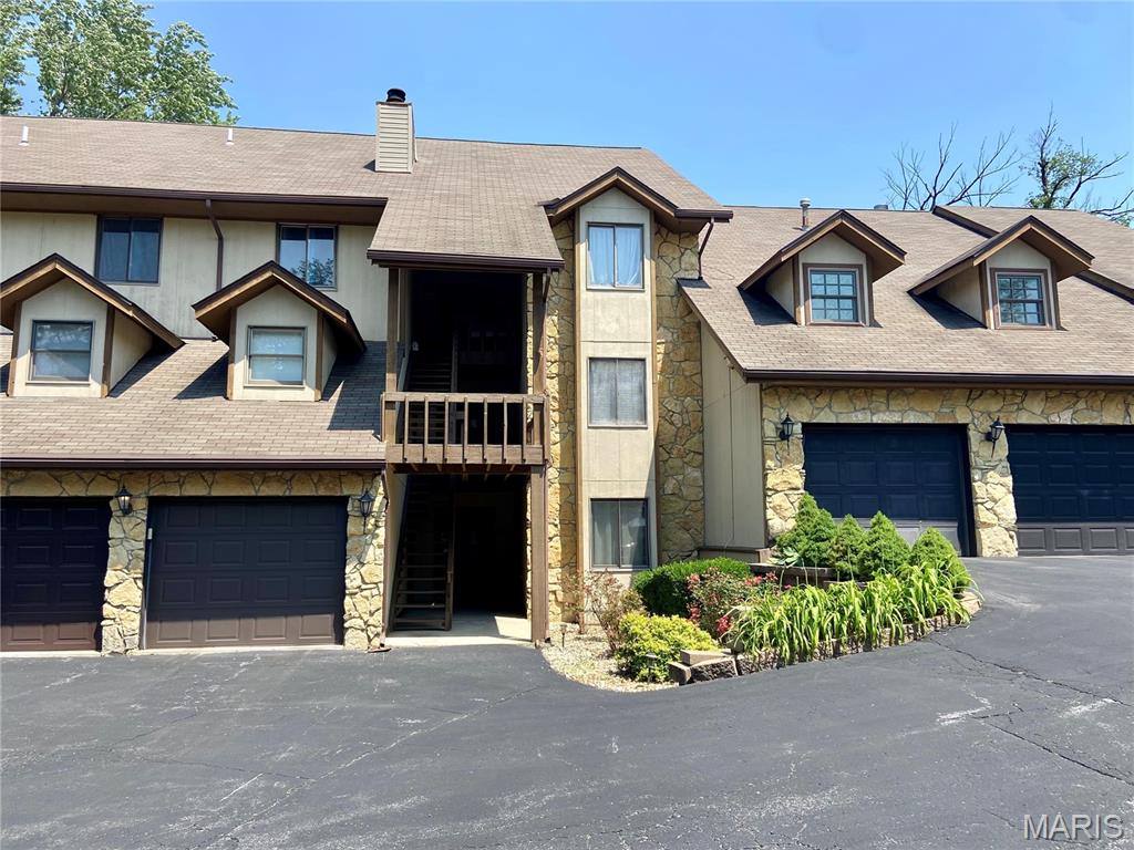 521 S 74th St, Belleville, IL 62223 - view of property featuring stone siding, a chimney, and a shingled roof