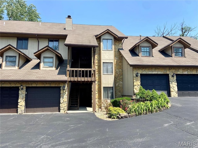 521 S 74th St, Belleville, IL 62223 - view of property featuring stone siding, a chimney, and a shingled roof