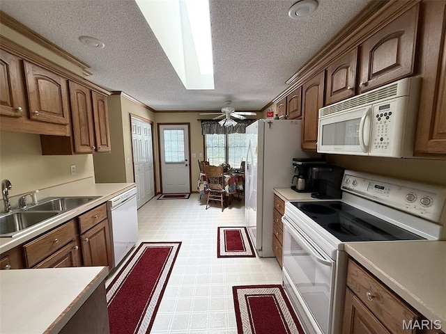 106 Woodland Hills Ct, Vandalia, IL 62471 - kitchen with white appliances, light flooring, a textured ceiling, a skylight, and light countertops