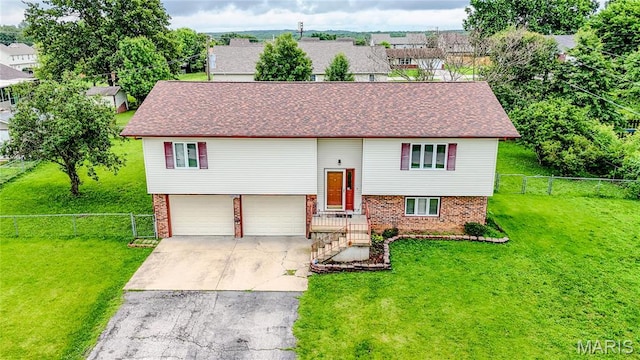 21730 Rudolph Rd, Waynesville, MO 65583 - bi-level home with brick siding, concrete driveway, an attached garage, and a shingled roof