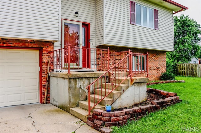 21730 Rudolph Rd, Waynesville, MO 65583 - property entrance featuring brick siding, concrete driveway, and a garage