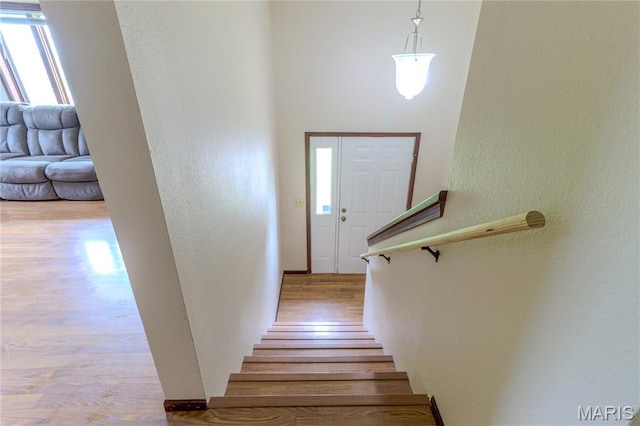 21730 Rudolph Rd, Waynesville, MO 65583 - stairway featuring a textured wall and wood finished floors