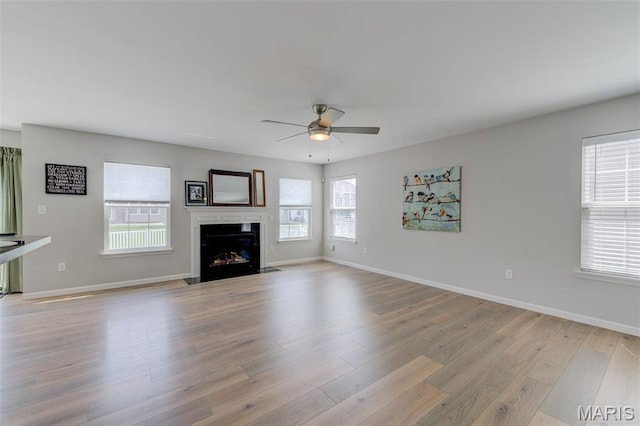 3325 Charlestowne Crossing Dr, Saint Charles, MO 63301 - unfurnished living room with a ceiling fan, light wood-style flooring, and a fireplace with flush hearth