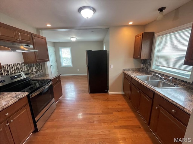 6155 Emerald Ave, Saint Louis, MO 63135 - kitchen with appliances with stainless steel finishes, under cabinet range hood, tasteful backsplash, light wood-style floors, and recessed lighting