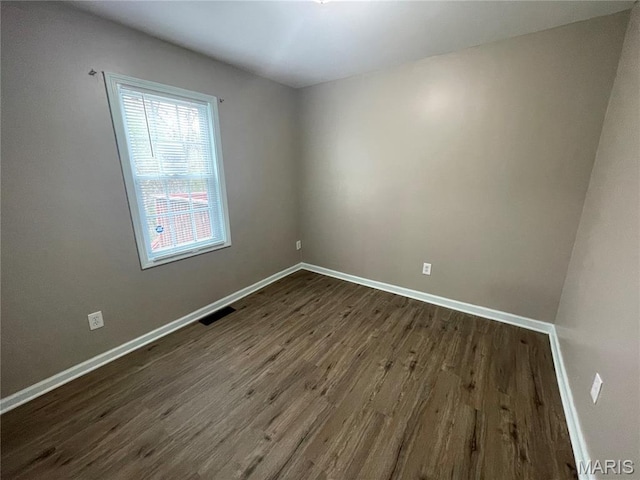 6155 Emerald Ave, Saint Louis, MO 63135 - unfurnished room featuring dark wood-type flooring and baseboards