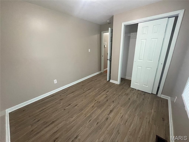 6155 Emerald Ave, Saint Louis, MO 63135 - unfurnished bedroom featuring dark wood finished floors and a closet