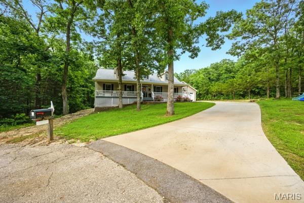 9 Sun Trail, Rise Trail, MO 63050 - view of front of home featuring a porch, a front yard, and concrete driveway