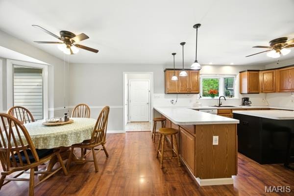 9 Sun Trail, Rise Trail, MO 63050 - kitchen featuring brown cabinets, ceiling fan, light countertops, and a breakfast bar