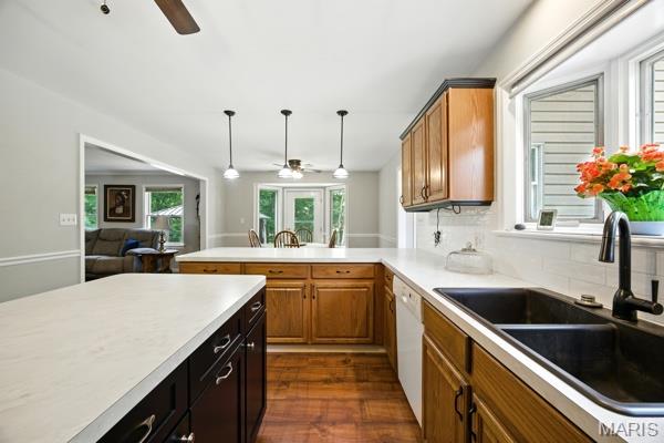 9 Sun Trail, Rise Trail, MO 63050 - kitchen featuring a ceiling fan, light countertops, brown cabinets, and backsplash