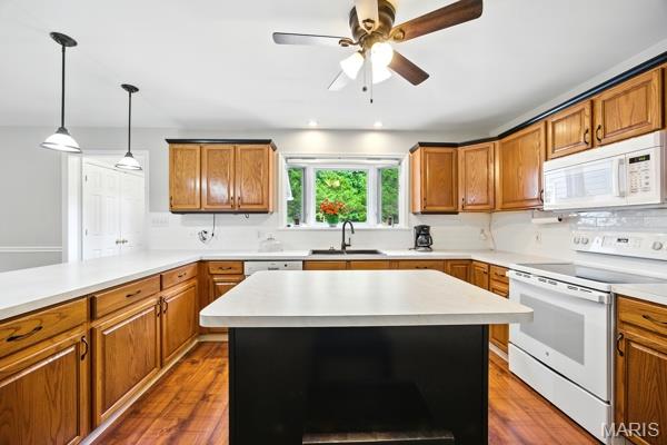 9 Sun Trail, Rise Trail, MO 63050 - kitchen featuring white appliances, brown cabinetry, light countertops, and dark wood-style flooring