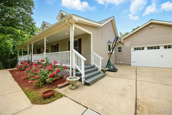 9 Sun Trail, Rise Trail, MO 63050 - view of front of property featuring a porch and a detached garage
