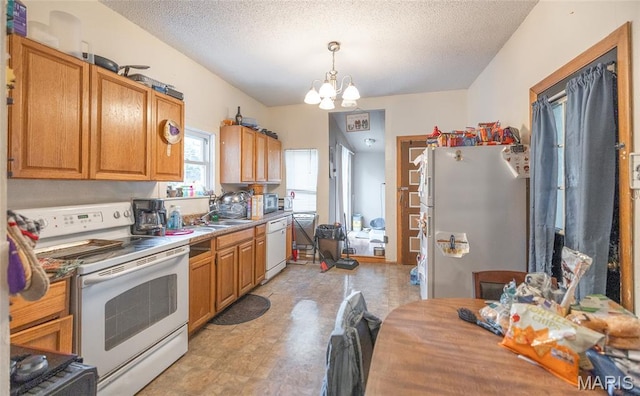 2008 Vienna Rd, Rolla, MO 65401 - kitchen with white appliances, light flooring, a chandelier, a textured ceiling, and pendant lighting