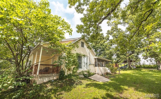 2008 Vienna Rd, Rolla, MO 65401 - view of side of property with a lawn and a sunroom