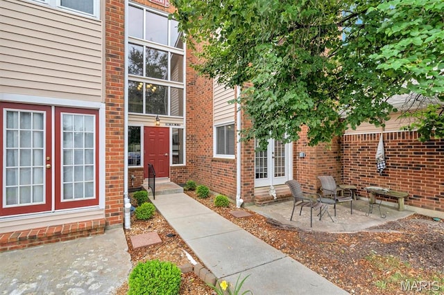 1308 Holgate Dr Unit G5, Ballwin, MO 63021 - property entrance featuring brick siding, a patio, and french doors