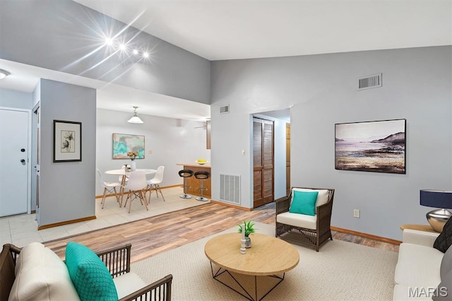 1308 Holgate Dr Unit G5, Ballwin, MO 63021 - living area featuring light wood-type flooring and high vaulted ceiling