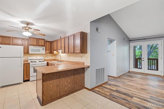 1308 Holgate Dr Unit G5, Ballwin, MO 63021 - kitchen with white appliances, light countertops, a peninsula, light tile patterned floors, and brown cabinets