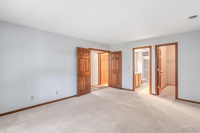 1308 Holgate Dr Unit G5, Ballwin, MO 63021 - unfurnished bedroom with light colored carpet, a walk in closet, a closet, and connected bathroom