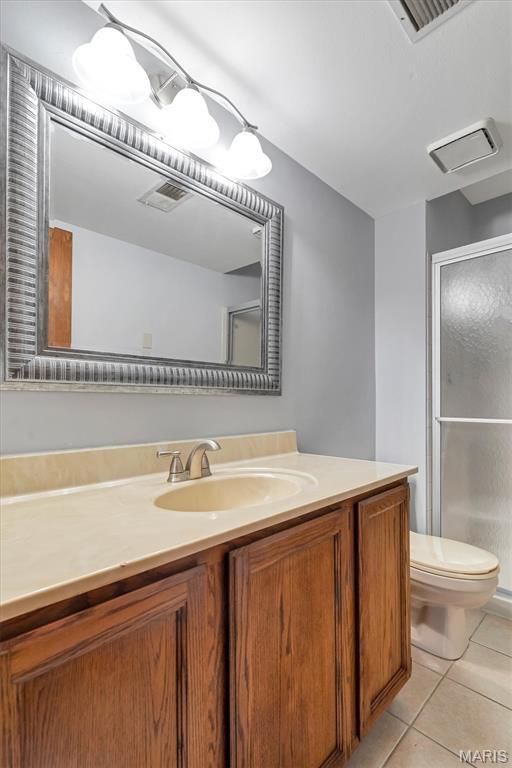 1308 Holgate Dr Unit G5, Ballwin, MO 63021 - bathroom featuring vanity, a stall shower, and tile patterned floors