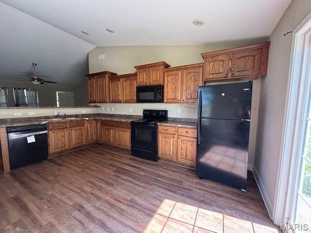 2069 State Highway H, Sikeston, MO 63801 - kitchen featuring black appliances, dark wood-style floors, vaulted ceiling, brown cabinetry, and a ceiling fan