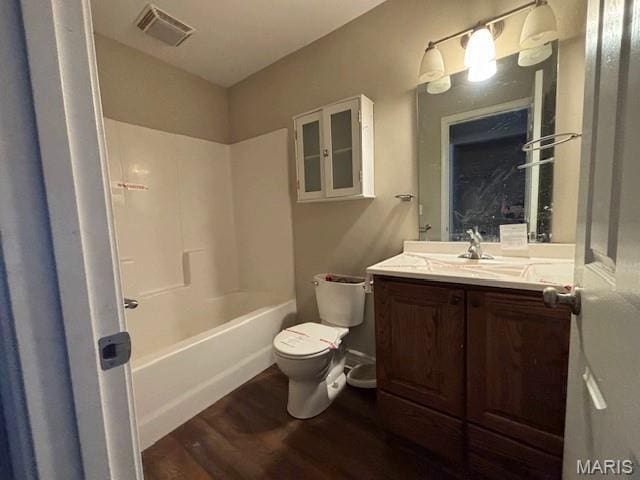 2069 State Highway H, Sikeston, MO 63801 - bathroom featuring wood finished floors, vanity, and tub / shower combination