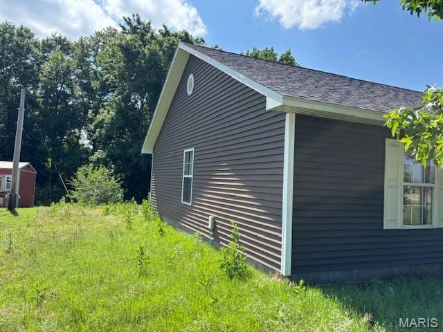 2069 State Highway H, Sikeston, MO 63801 - view of home's exterior with a shingled roof and a storage unit