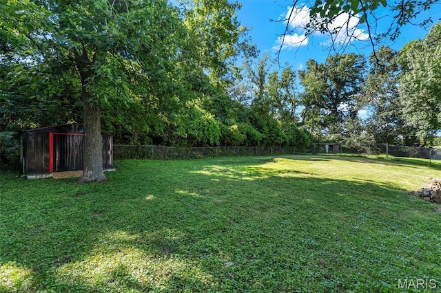 321 Fairview Ct, Ballwin, MO 63021 - fenced backyard featuring a storage unit